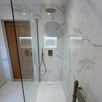fitted shower with gold taps
