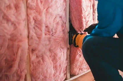 man fitting insulation